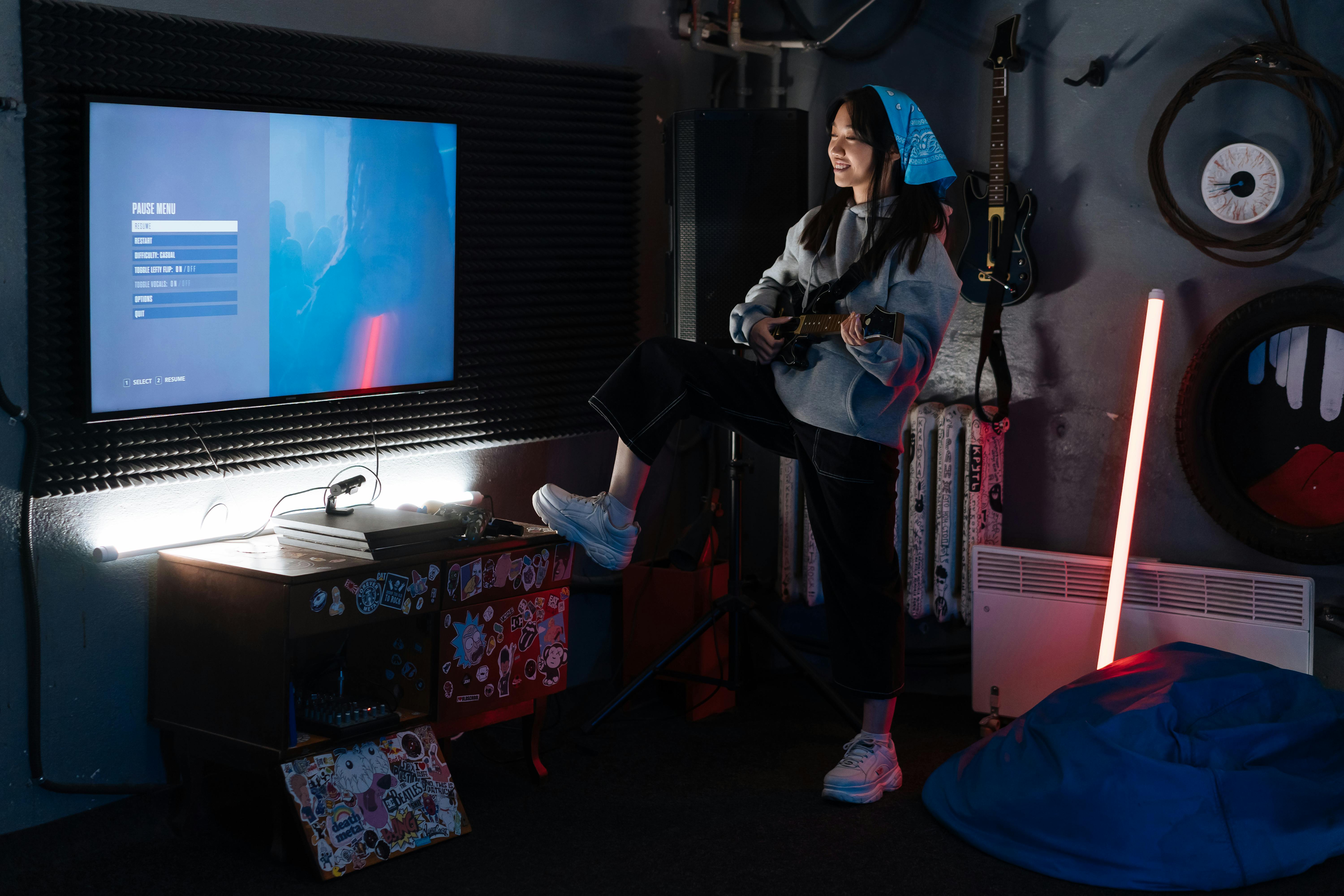 woman with blue bandana playing guitar