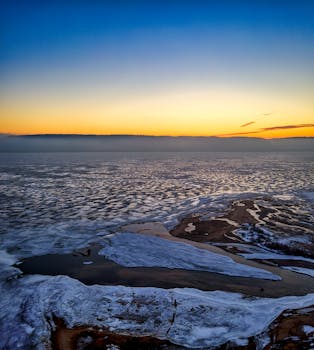 Stunning aerial capture of a frozen lake at dawn, showcasing winter's beauty in Minnesota.