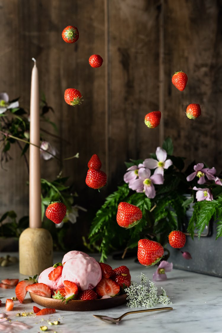 Strawberries Falling Down On A Table