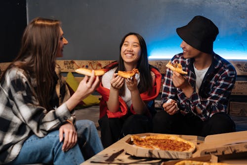 Free Teens Eating Pizza while Sitting Stock Photo
