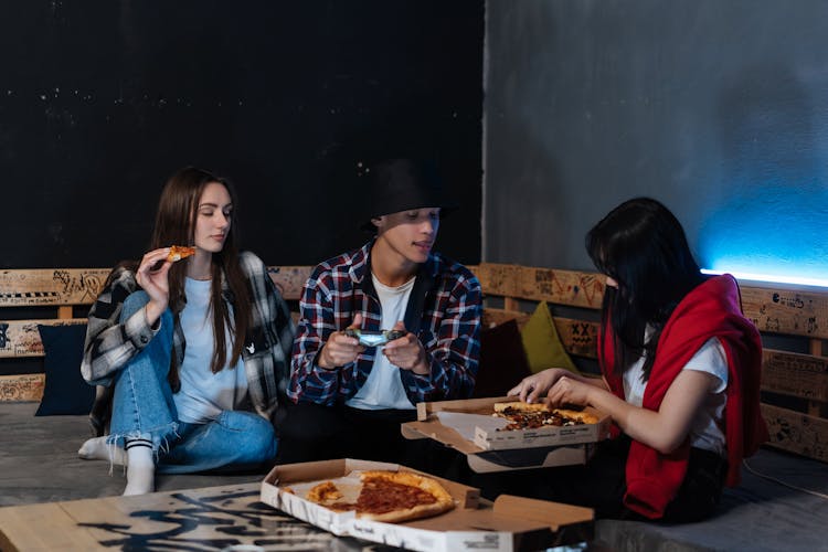 Happy Friends Hanging Out Together And Eating Pizza 
