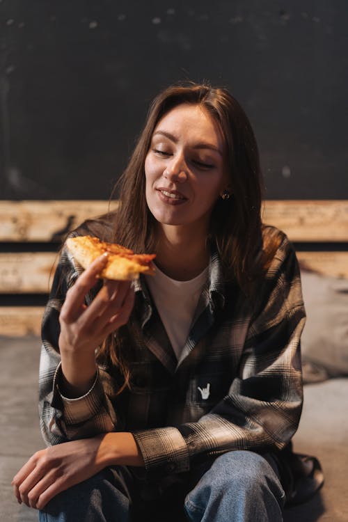 A Woman Holding a Pizza 