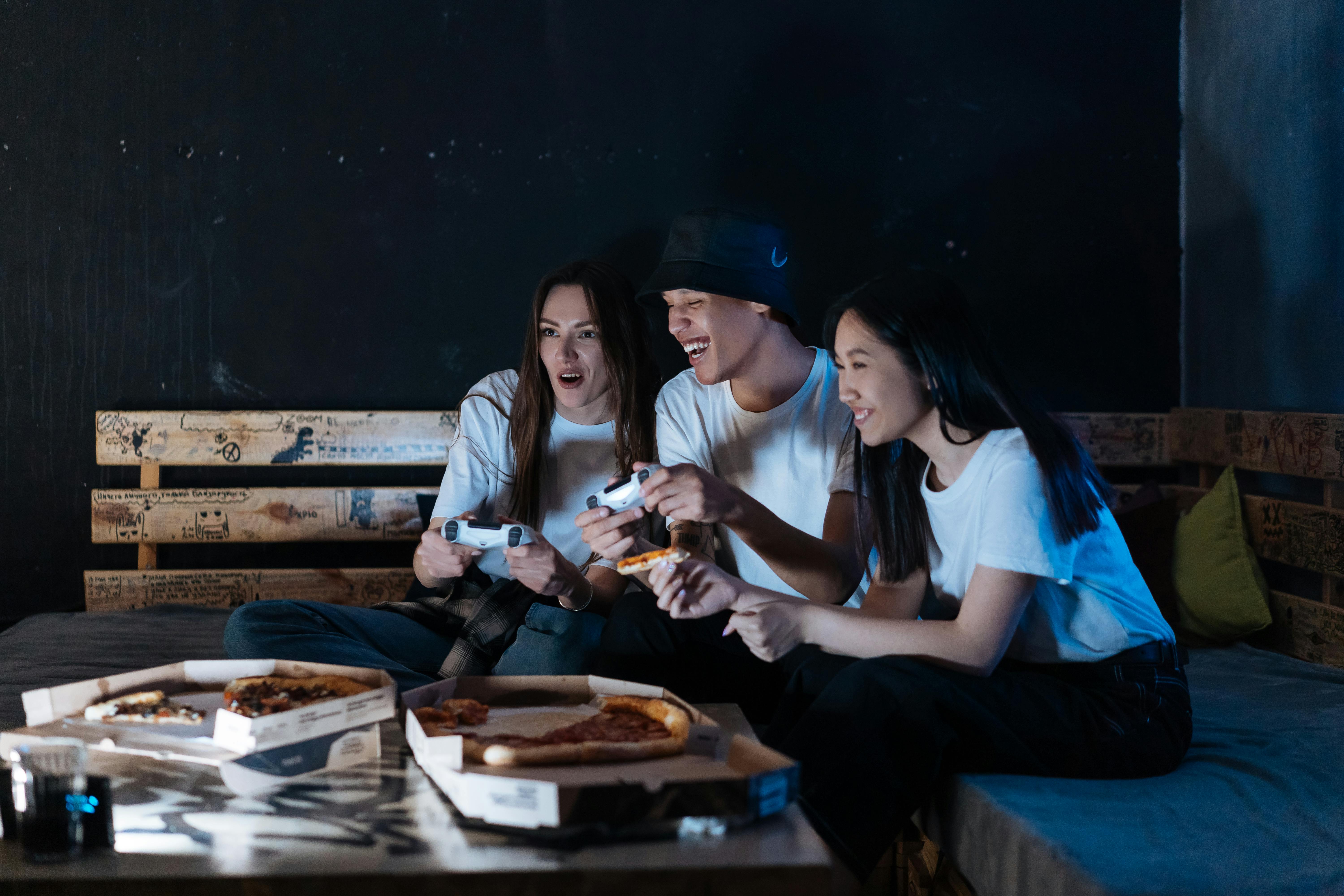 People Playing While Eating Pizza · Free Stock Photo