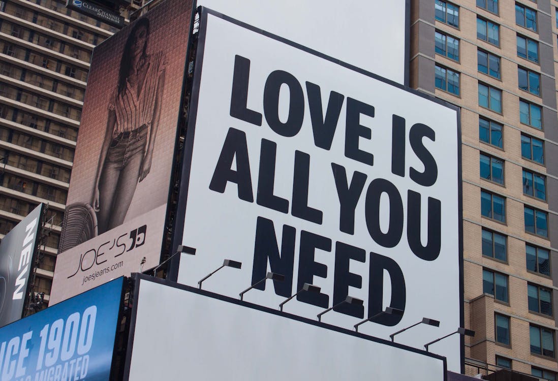 Free Love Is All You Need Signage Stock Photo