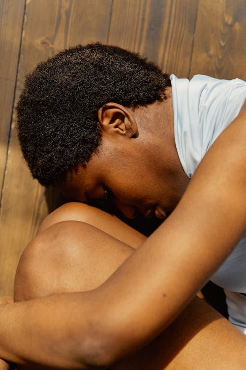 A Woman Curled Up on the Floor