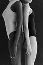 Two Girls Standing Back to Back