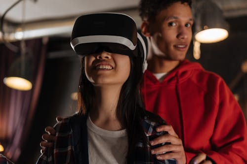 A Man Holding a Woman while Playing Virtual Reality