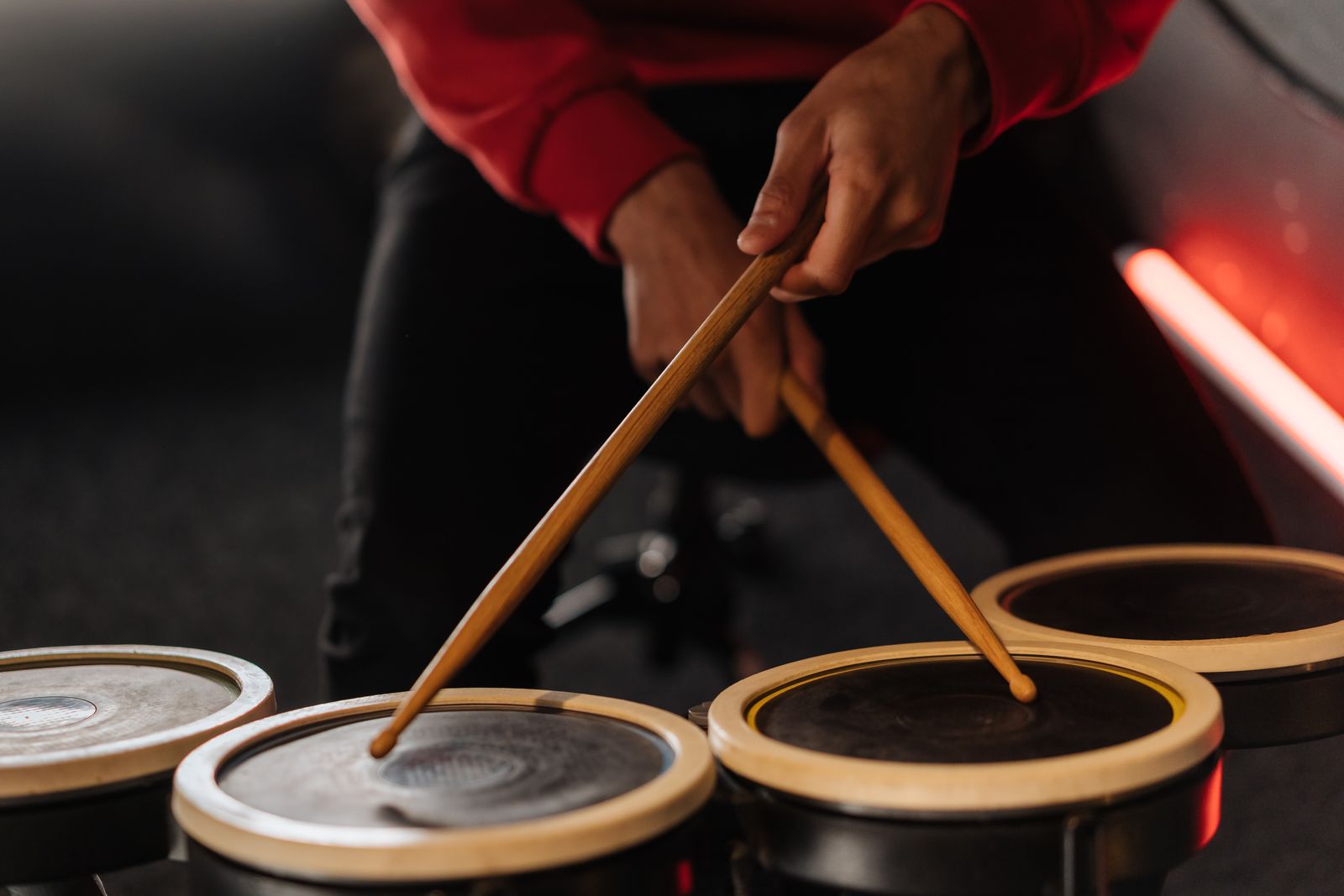 Hands holding drumsticks, ready to play — the practice pad setup that fits anywhere