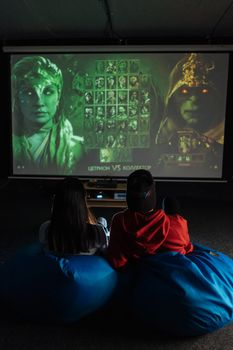 Two people enjoying a gaming session inside, displayed on a large screen.