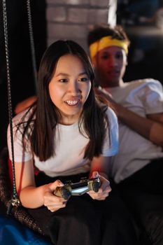 Friends having fun gaming indoors with a controller. Engaging and playful atmosphere.