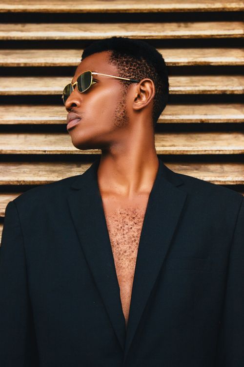 Free Portrait of a fashionable young Black man wearing sunglasses and a suit, exuding confidence. Stock Photo
