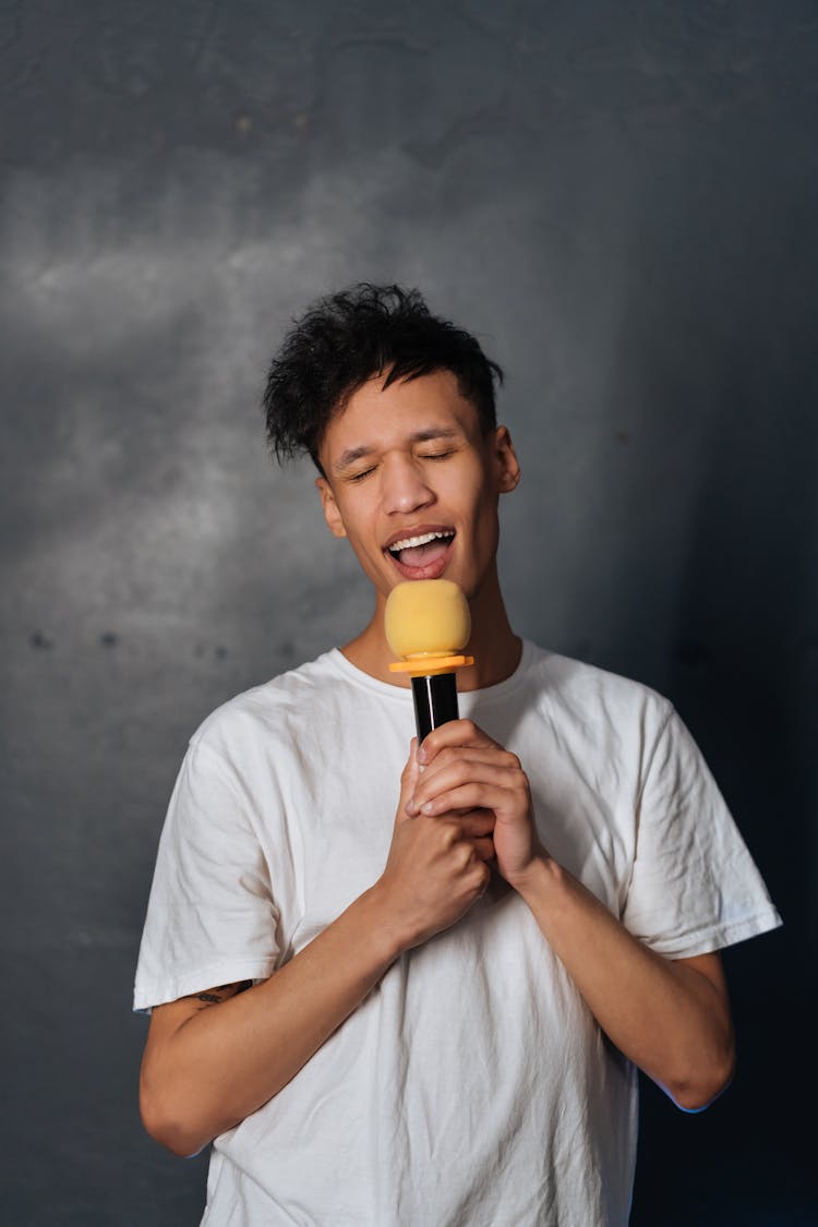 Man Holding A Microphone Singing