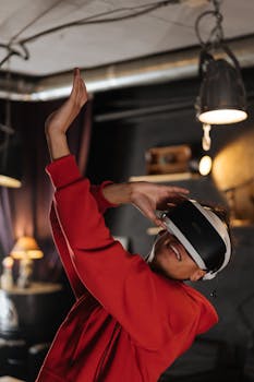 A man in a red hoodie enjoying a virtual reality experience indoors, engaging with the metaverse.
