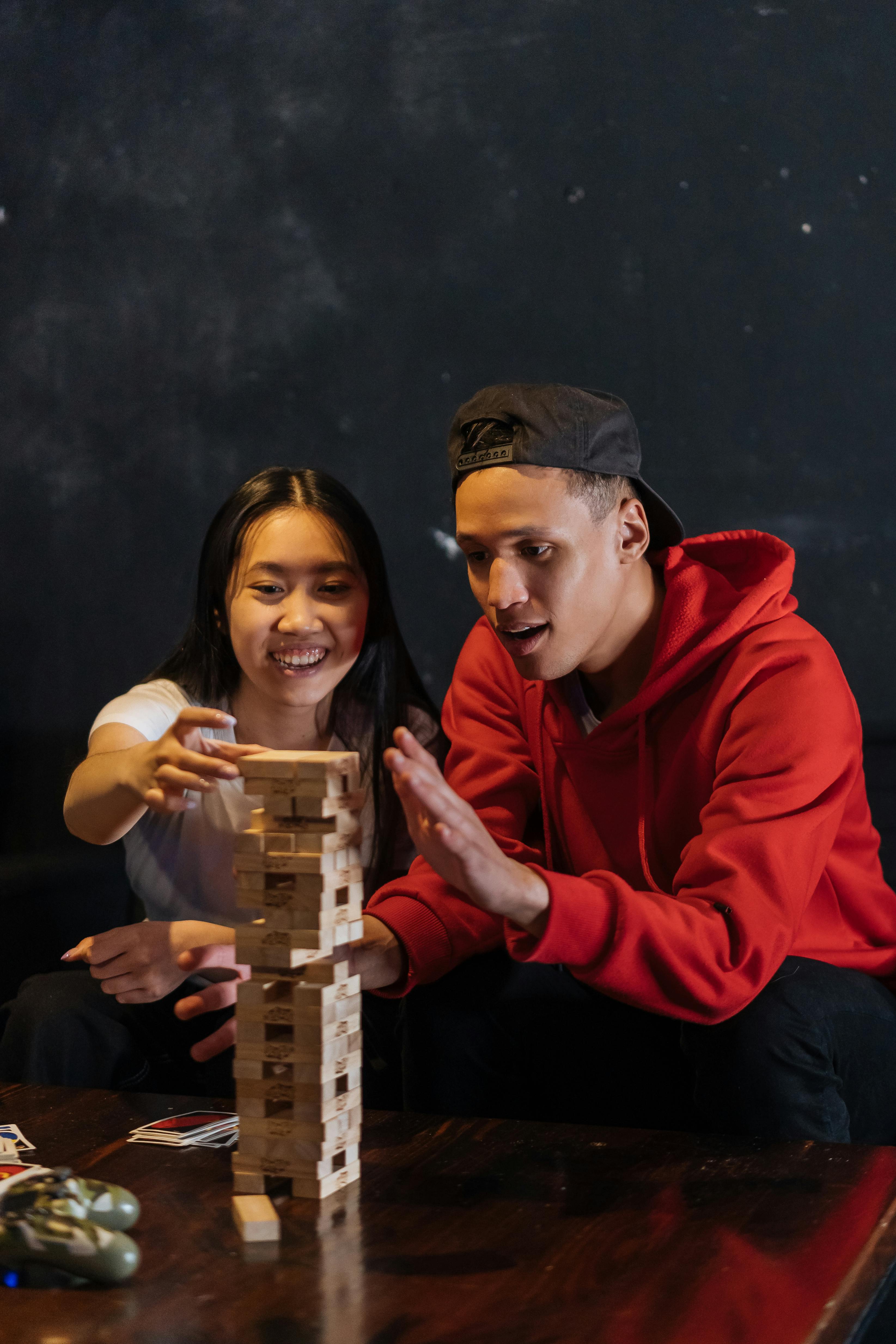 a man and woman playing jenga