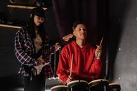 Man in Red Zip Up Jacket Playing Drum