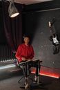Man in Red Long Sleeve Shirt Playing Electric Guitar