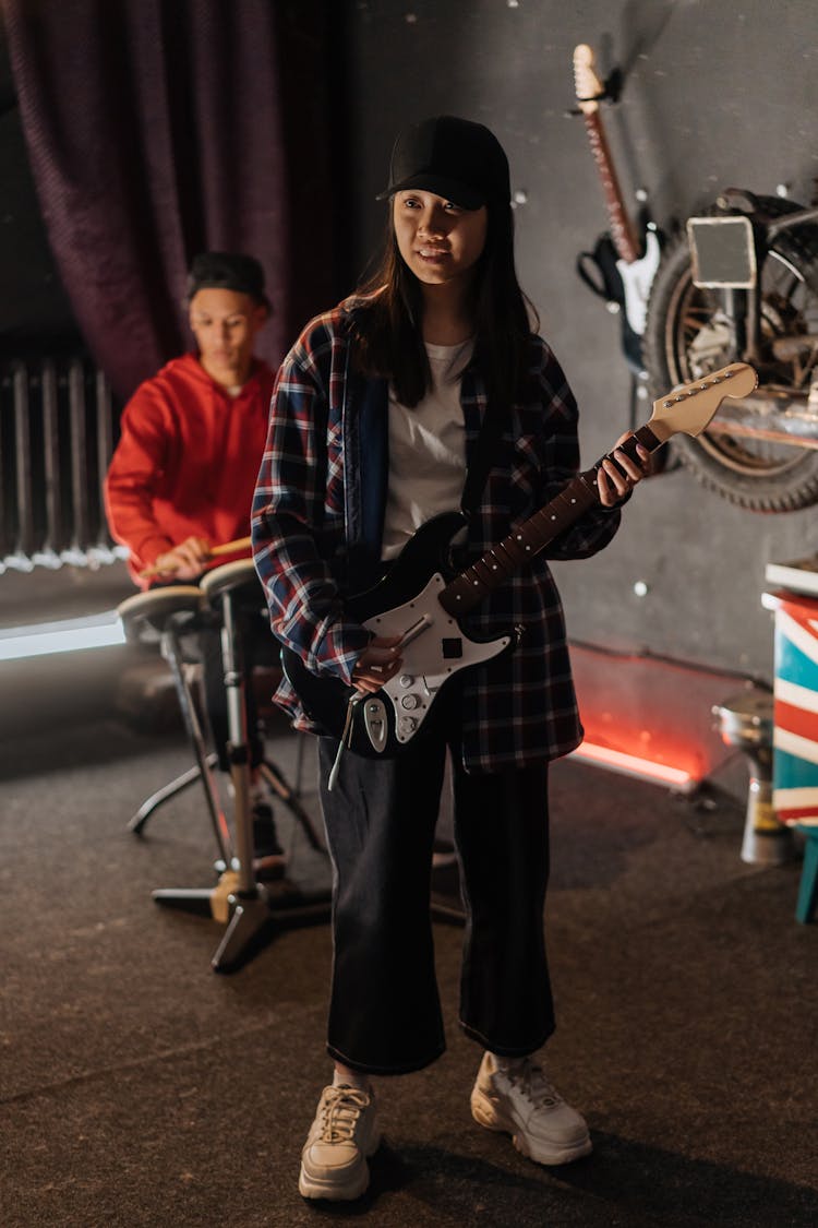 Woman Holding A Guitar Shape Game Controller