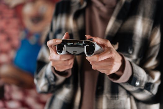 Close-up of hands holding a game controller, showcasing modern technology and gaming lifestyle.