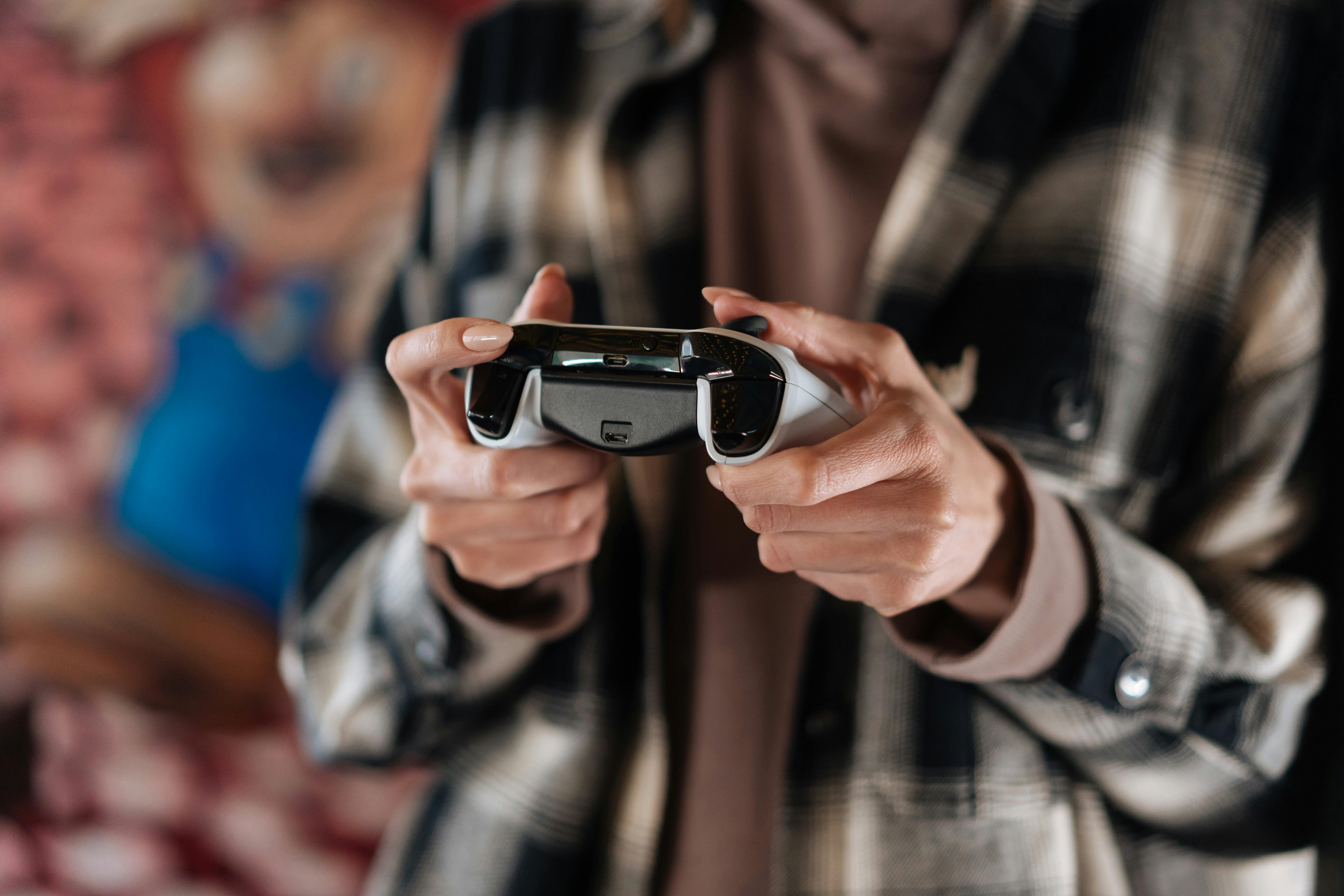 Free Photo  Person playing video games with controller on