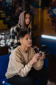 Two young adults intensely focused on playing video games indoors.