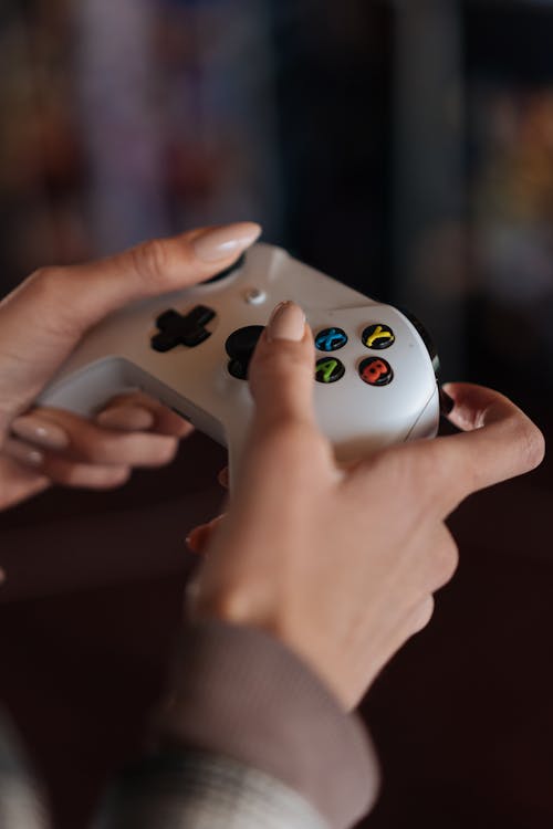 Person Holding White Xbox Game Controller