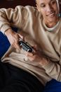 A Man in a Sweater Playing Video Games