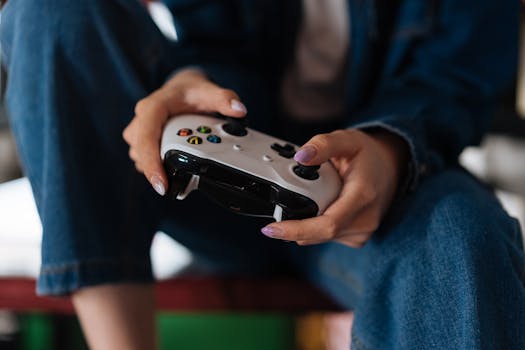 Hands holding a game controller during intense gameplay session.