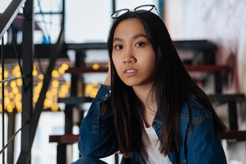 Young Woman in Blue Denim Jacket and White Shirt