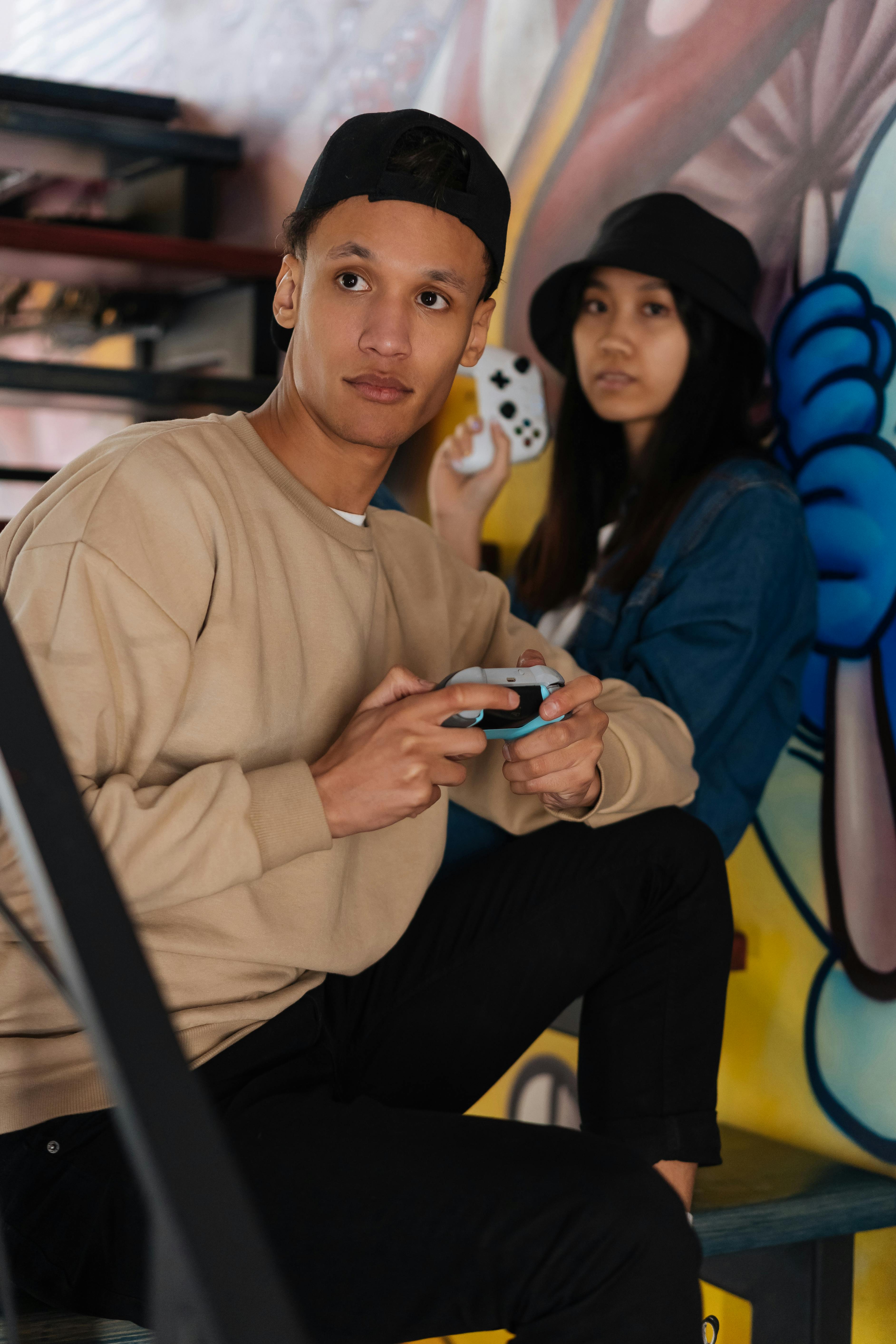 man and woman holding game controllers