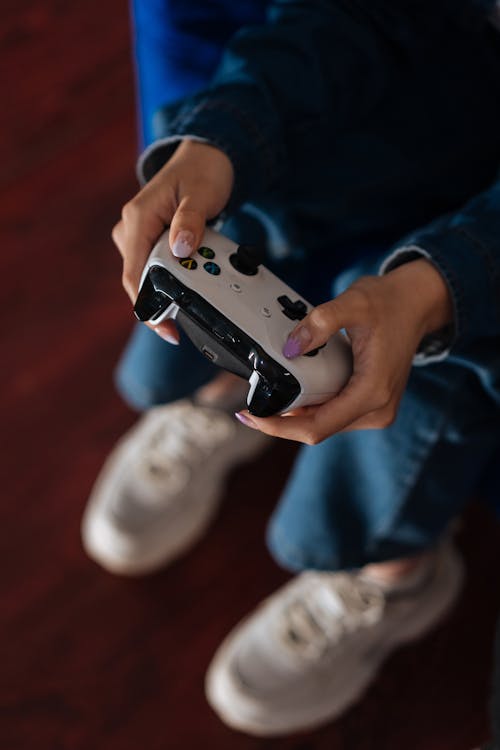 Person Using A Wireless Game Controller · Free Stock Photo