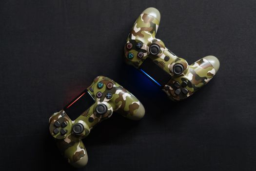 Close-up of two camouflage game controllers, perfect for gaming enthusiasts.