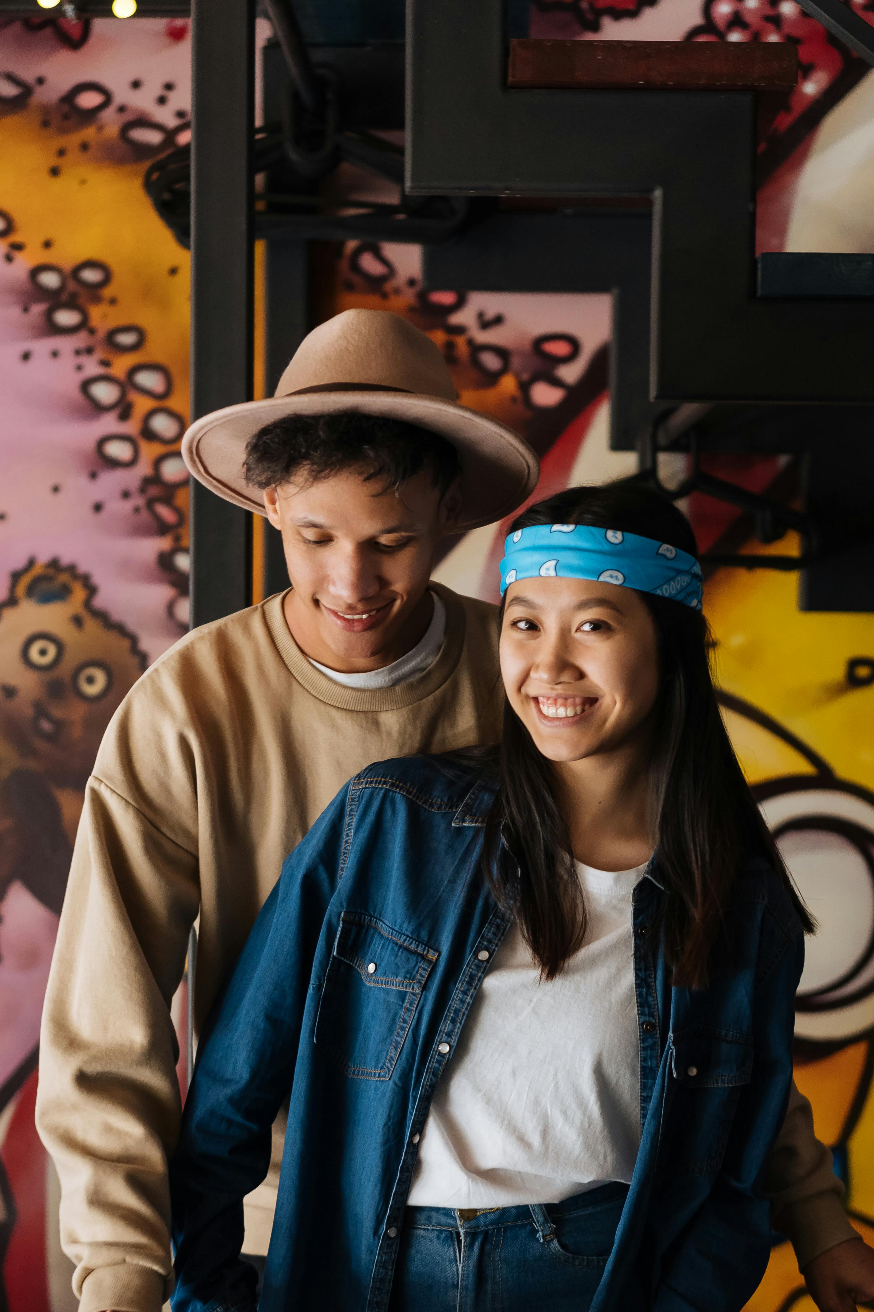 photo of a boy with a hat near a girl smiling