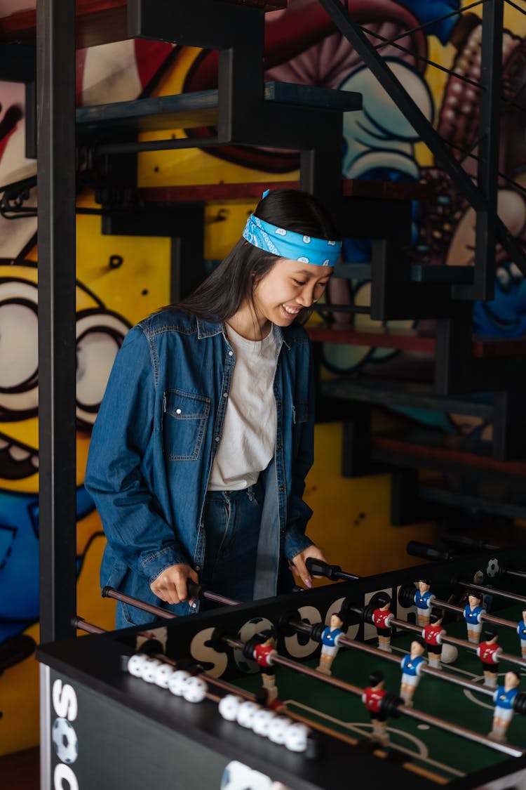 A Woman Playing Foosball Table Game