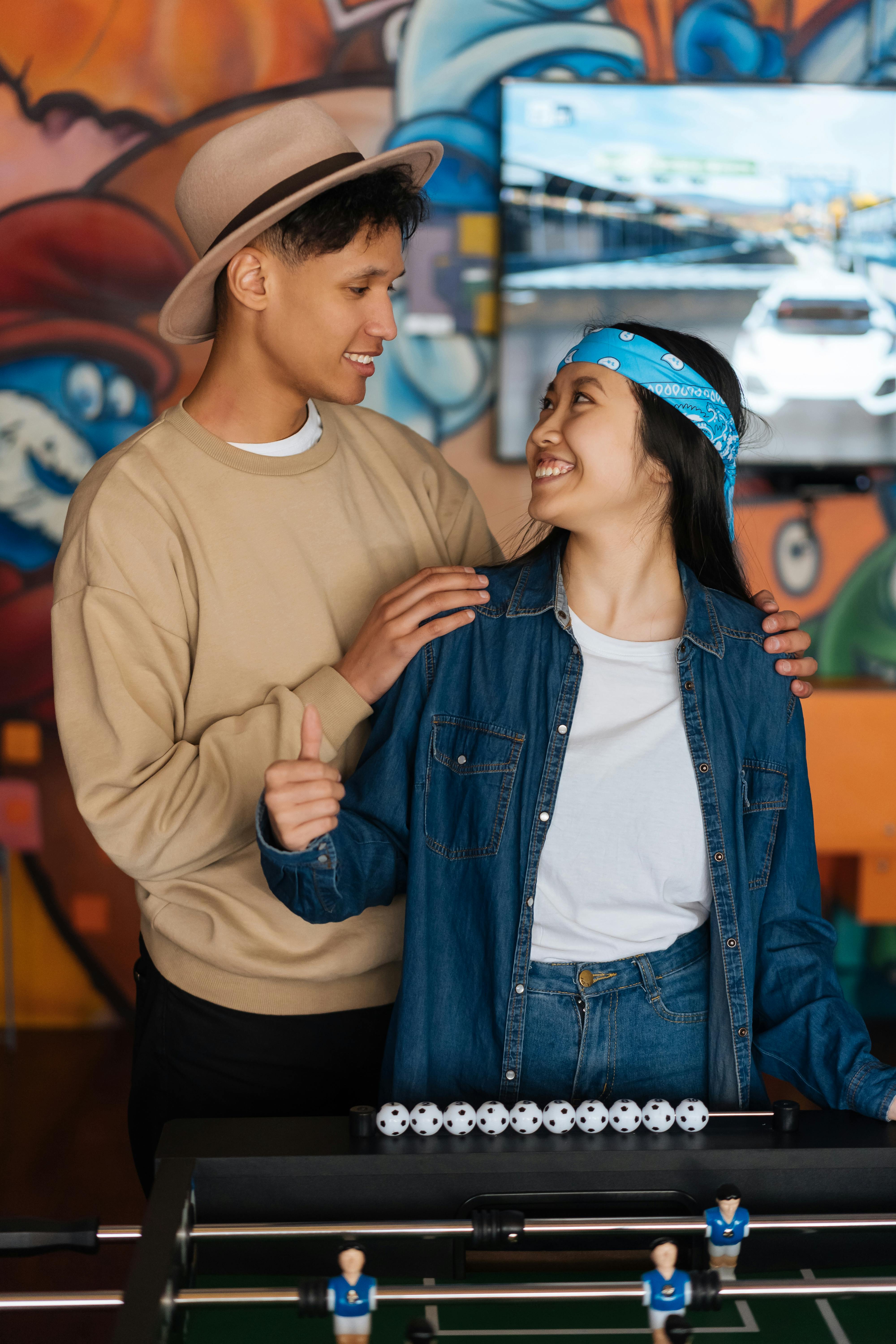 man and woman playing foosball