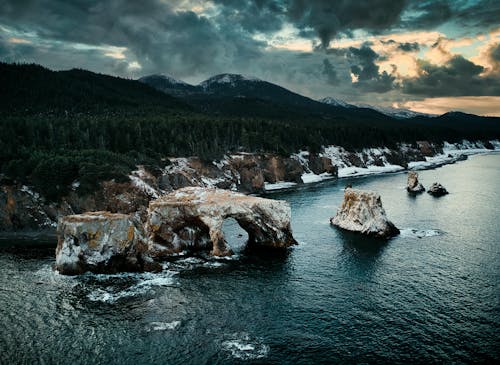 Free Rock Formations Along a Coastline Under Gloomy Sky Stock Photo