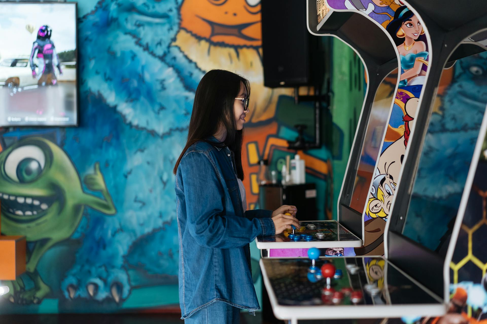 Woman Wearing a Denim Jacket Playing a Video Game