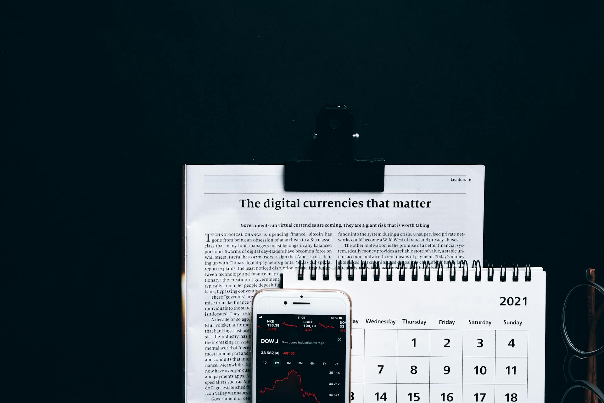 Smartphone, Calendar and Printout on a Black Surface