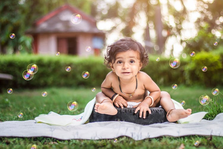 Baby Girl Among Soap Bubbles