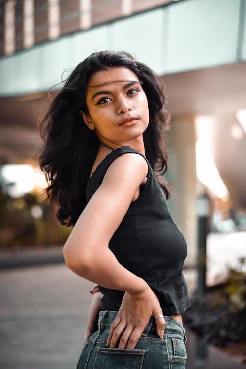 Woman Wearing Black Tank Top with Hands on Waist