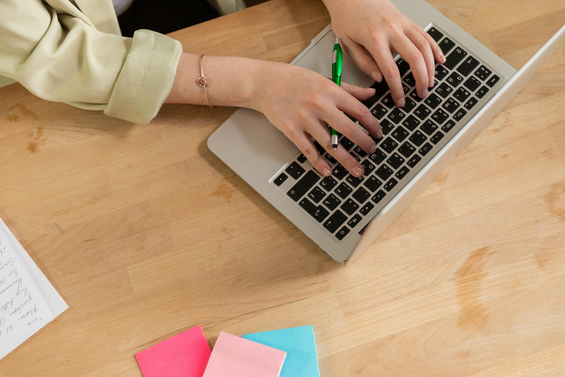 A Person Typing on a Laptop