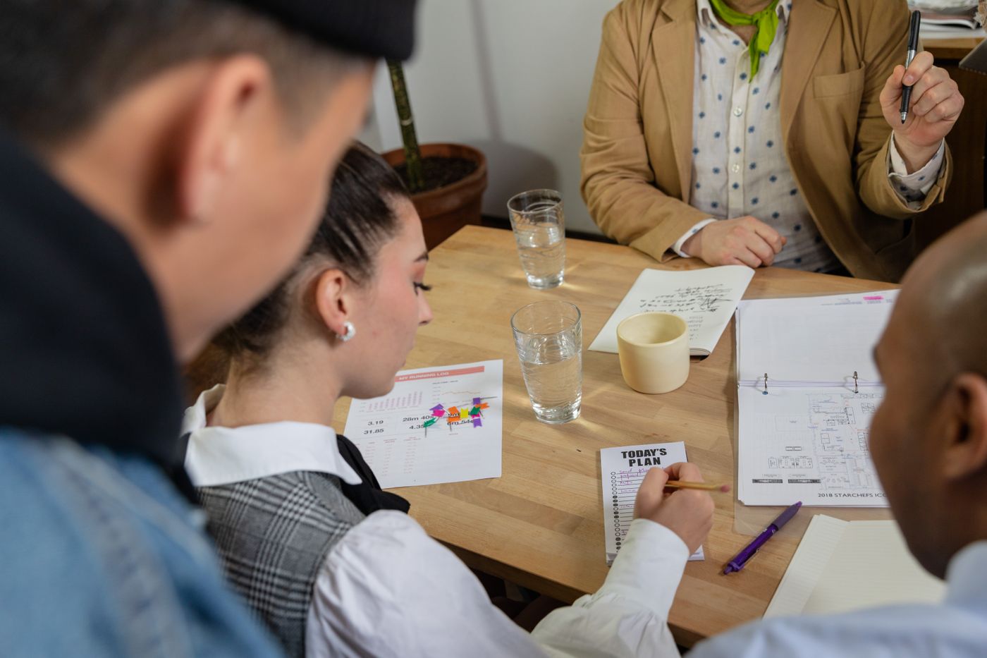 A diverse group of professionals discussing plans and documents together