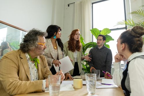 Free A group of professionals engaged in a collaborative business meeting in a modern office setting. Stock Photo