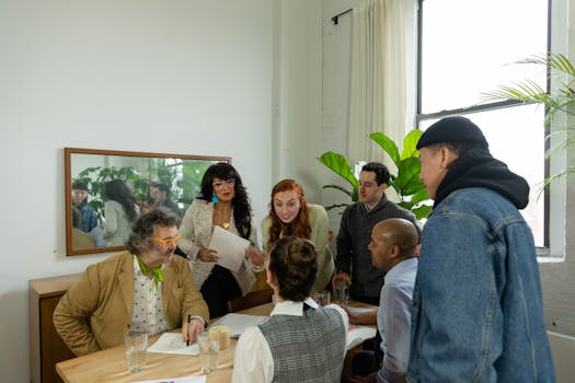 A diverse group of coworkers brainstorming in a modern office setting.