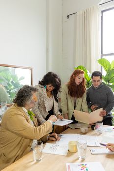 Group of diverse colleagues collaborating in a bright office space.