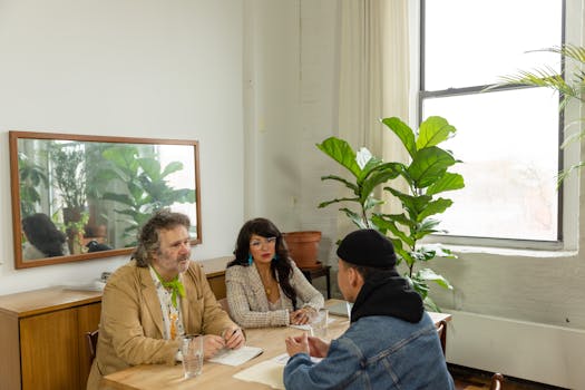 A diverse team discussing strategy in a contemporary office with plants.