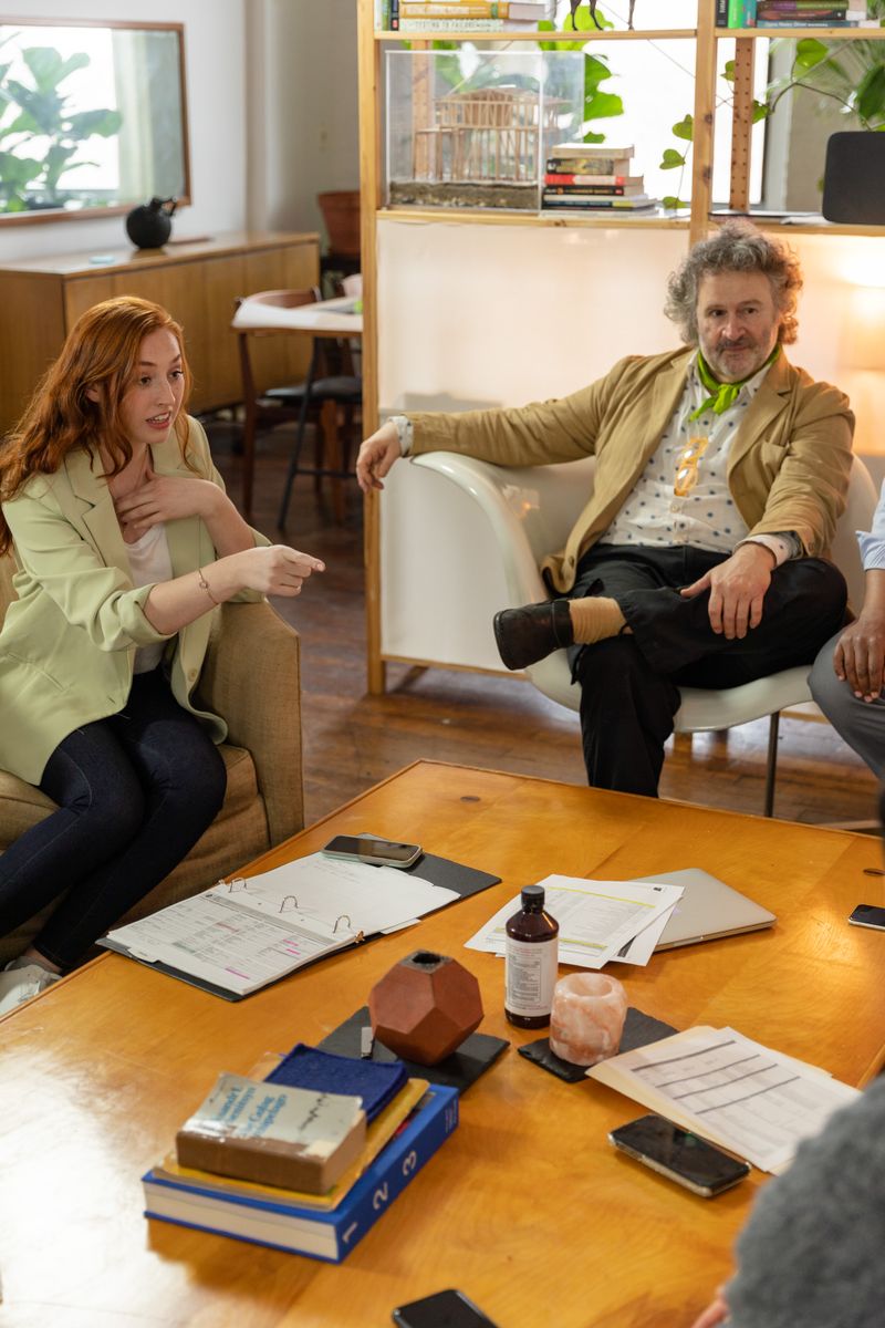 Business team engaged in a lively brainstorming session with documents and technology at hand.