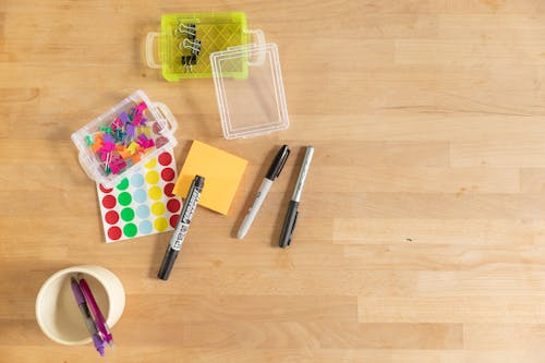 Office Supplies and Writing Materials on Wooden Surface