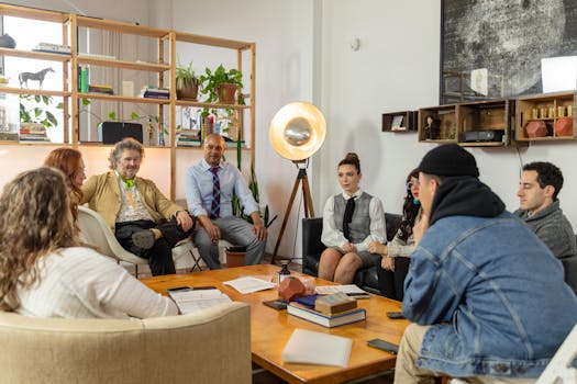 A diverse team gathered for a meeting in a modern office with creative decor, discussing plans.