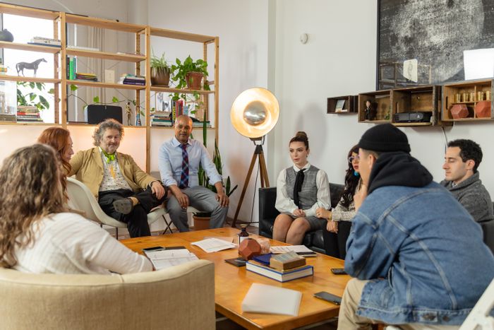 A team gathered around a table in a modern office — photo by RDNE Stock project on Pexels