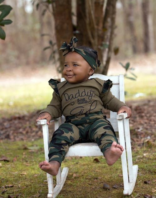 Free Baby Girl Sitting on White Chair Stock Photo